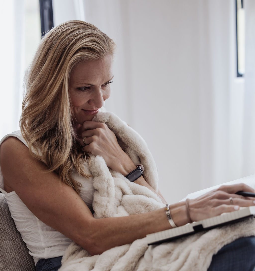 Jessie journaling, wrapped in a blanket